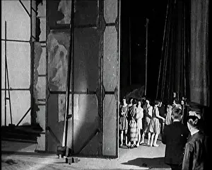 Technicians: A Theatre Set Being Revolved By Stage Technicians