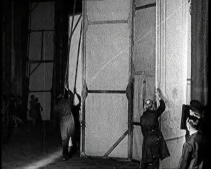 Technicians: A Theatre Set Being Revolved By Stage Technicians