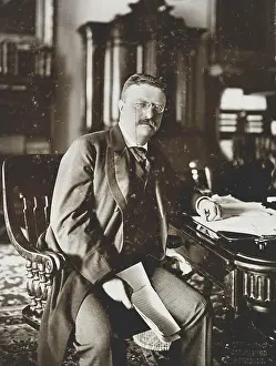 C1902: Theodore Roosevelt seated at desk, facing front