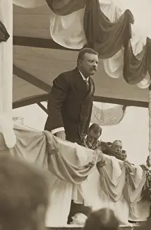4 People: Theodore Roosevelt speaking at from a bunting draped