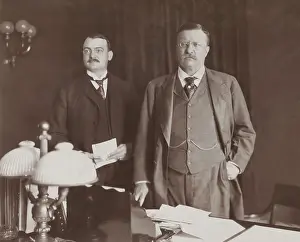 Loeb: Theodore Roosevelt standing behind desk, with Asst