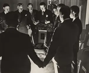 Afterlife: Thirteen magicians clasping hands in a midnight