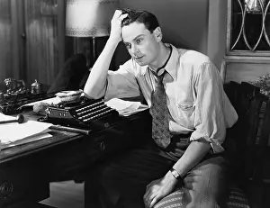 Brood: Thoughtful man at a typewriter