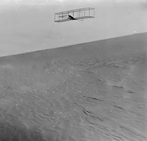 Glides: Three-quarter right front view of Wright glider descending f
