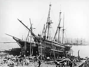 Masted: Threemasted vessel in a dockyard