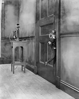 Shrunk: Tiny man hanging from key in door