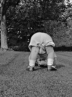 Nappies: Toddler bending over in a garden