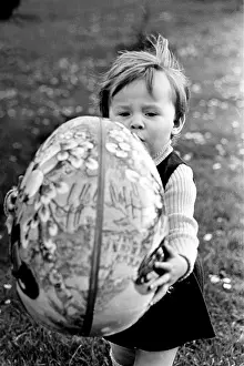 Carring: Toddler with big easter egg