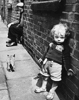 Brickwork: Toddler leaning against wall of house