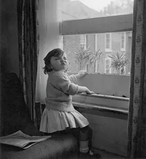 Wallflowers: Toddler at an open sash window, pulling a face