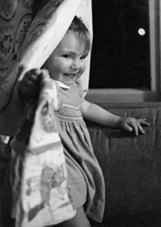 Smocked: Toddler peeping from behind a curtain