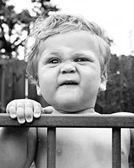 Playpen: Toddler in a playpen in a garden
