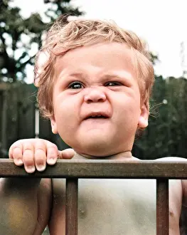 Fingers: Toddler in a playpen in a garden
