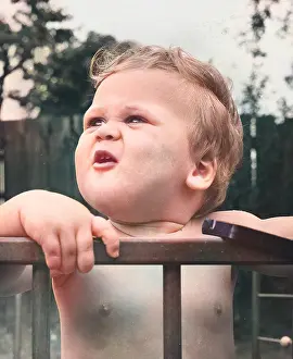 Fingers: Toddler in a playpen in a garden