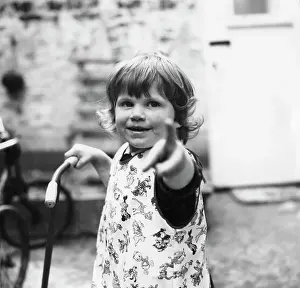 Tabard: Toddler pointing and looking straight at the camera