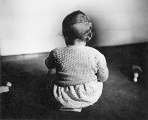 Toddler sitting on a carpet