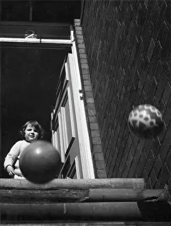 Bouncing: Toddler watching two balls bouncing down steps
