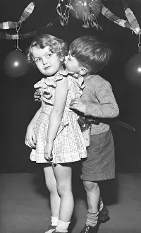 Gingham: Two toddlers under the mistletoe