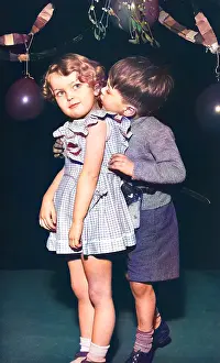 Garlands: Two toddlers under the mistletoe