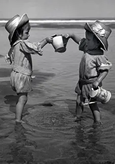 Playtime Nostalgia Photography: Two toddlers paddling in the sea