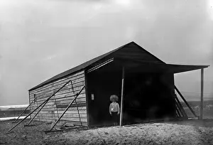 Tom Tate in front of camp building at Kitty Hawk, North Caro