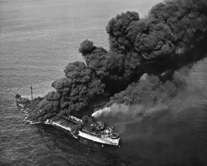Lcgr1407: A torpedoed American tanker burning after an Axis