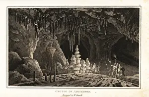 Stalactites: Tourists with torches exploring the Grotto of