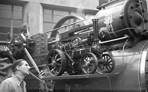 Newhall: Traction engine model on running board of a full size engine