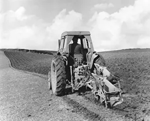 Furrows: TRACTOR PULLING A PLOUGH