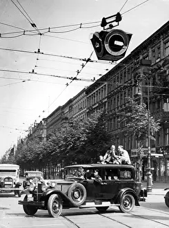Continuous: Traffic light and radio reporter at an intersection in Berli