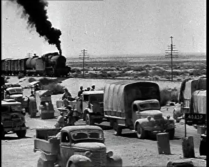 Motorised: A Train Riding Past a British Motorised Column