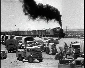 Motorised: A Train Riding Past a British Motorised Column