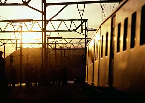 Glinting: Train with sunlight glinting off the carriages at sunset