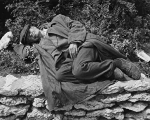 Scruffy: Tramp asleep on a flowerbed in Manchester