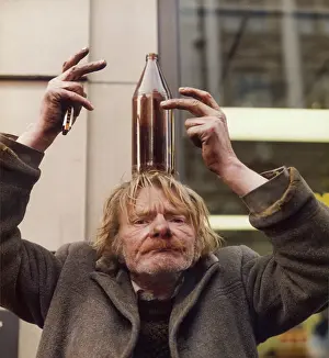 Balancing: Tramp balancing a beer bottle on his head