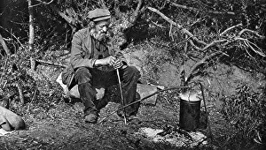 Fireside: A tramp sitting next to a fire