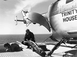 Scillies: Trinity House Service Helicopter on Bishop Rock lighthouse