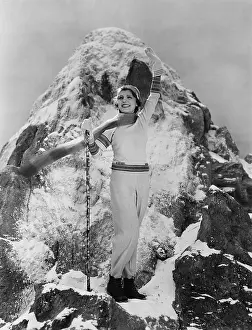 Accomplishment: Triumphant woman at mountain summit