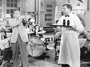 Displeased: Trombone player looking at a waiter in a bar