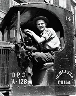 Trucking: Truck driver looking at camera in work shirt