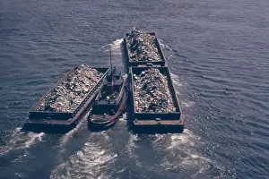 Staten: Tug boats tow barges of garbage down the ?
