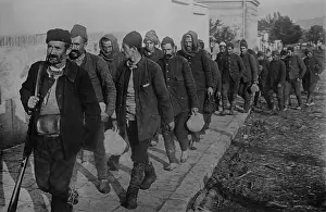 16 People: Turkish prisoners, led by an armed guard, enter