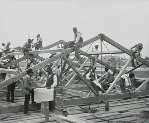15 People: Tuskegee Institute students constructing a roof