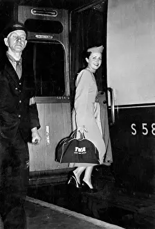 Stewardess: TWA air stewardess boarding a train