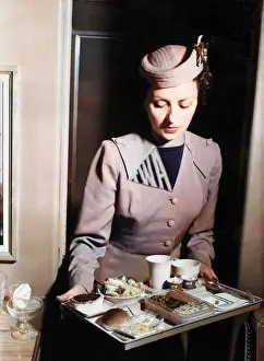 TWA air stewardess with an in-flight meal