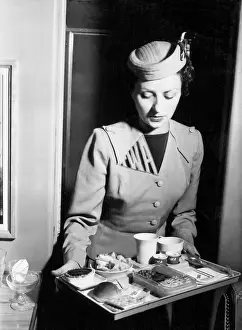 Inflight: TWA air stewardess with an in-flight meal