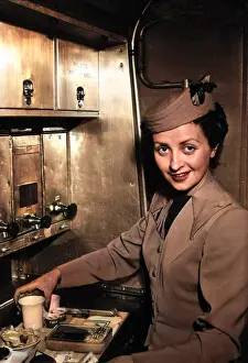 Inflight: TWA air stewardess prepares a meal