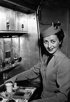 Inflight: TWA air stewardess prepares a meal