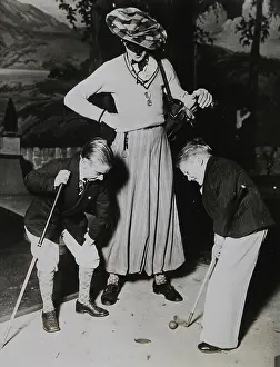 Lilliputians: 'Two Lilliputians with a caddy while