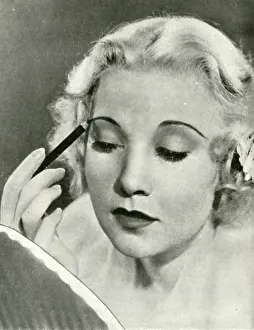 Eyebrow: Una Merkel, MGM star, applying Max Factor make up